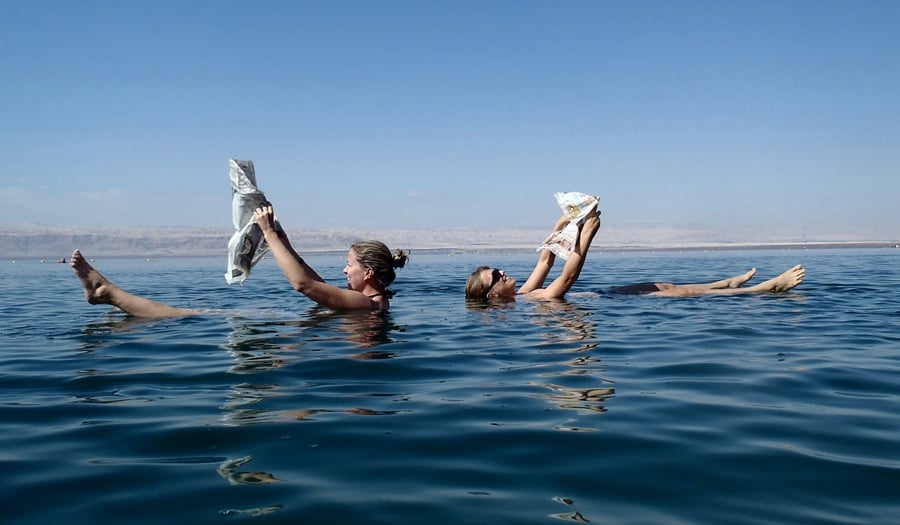 Reading newspapers in the dead sea in Jordan - an amazing thing to do in Jordan