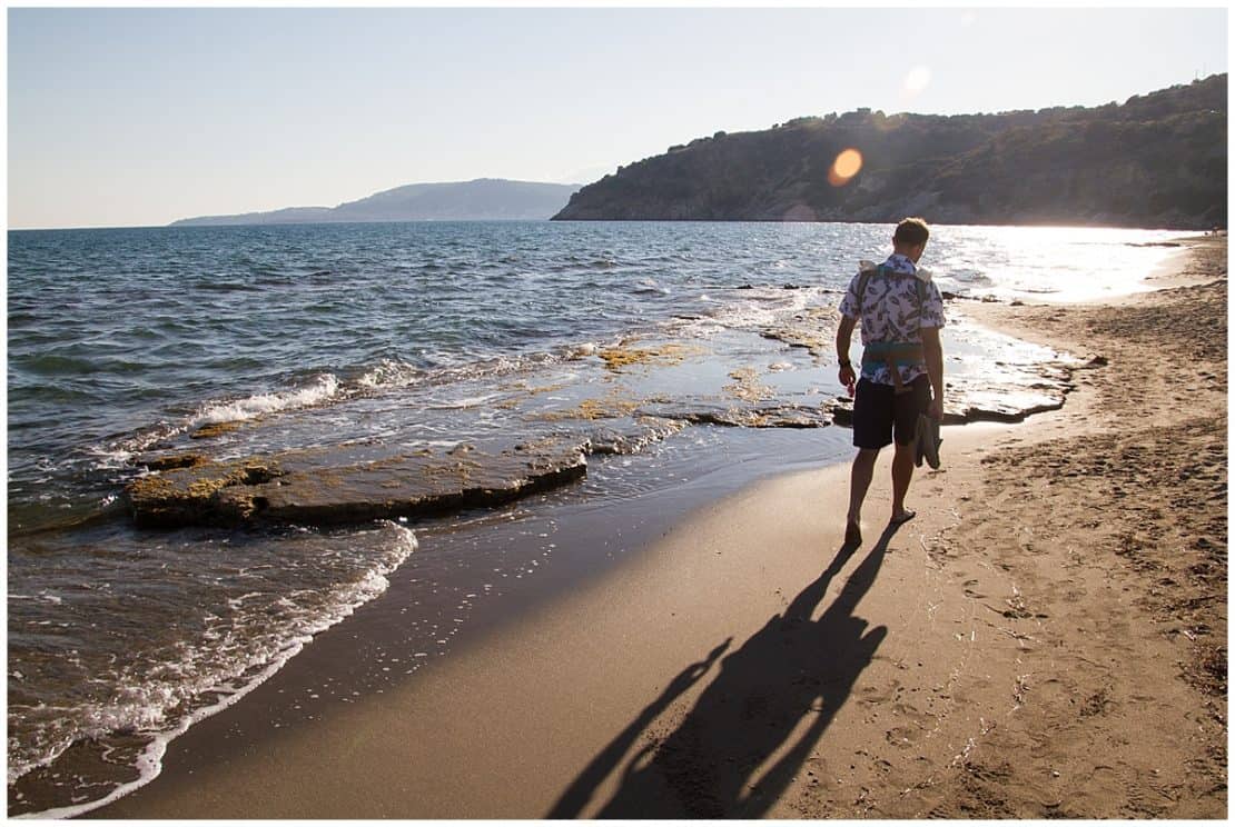 Man walking along the beaches of the Peloponnese - Best Peloponnese Itineraries