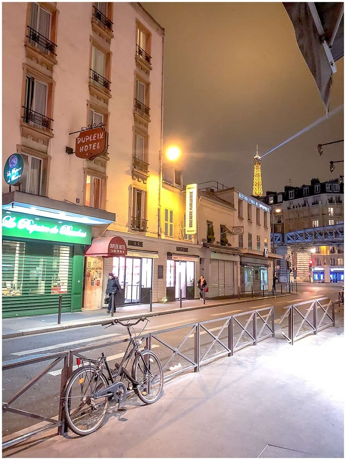 France - Paris - Bicycle in street scene near Dupleix Metro in Paris with view of Eiffel Tower