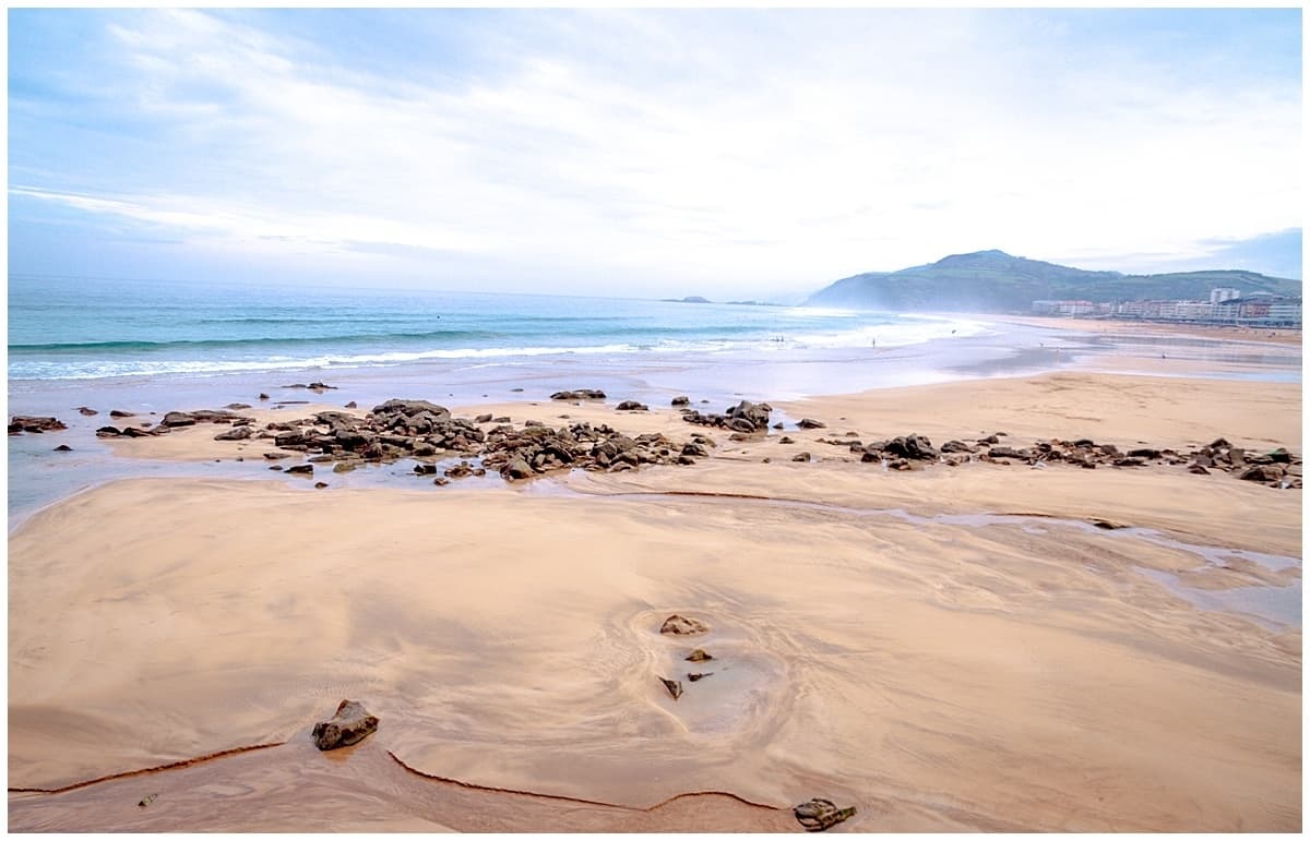 Sand shore with churning water along the coast from Donostia San Sebastian Spain