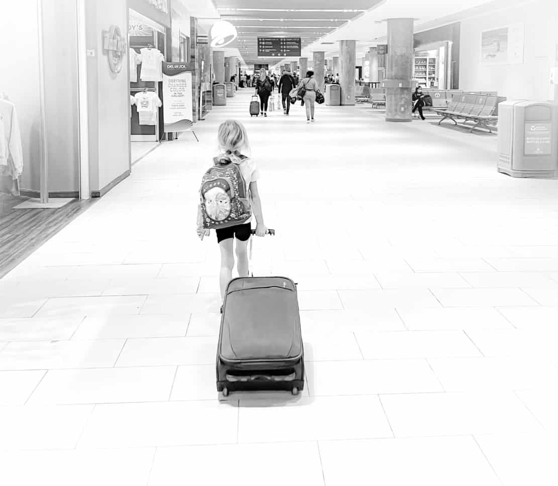 Child with suitcase in the airport at Punta Cana - best travel gifts for kids 