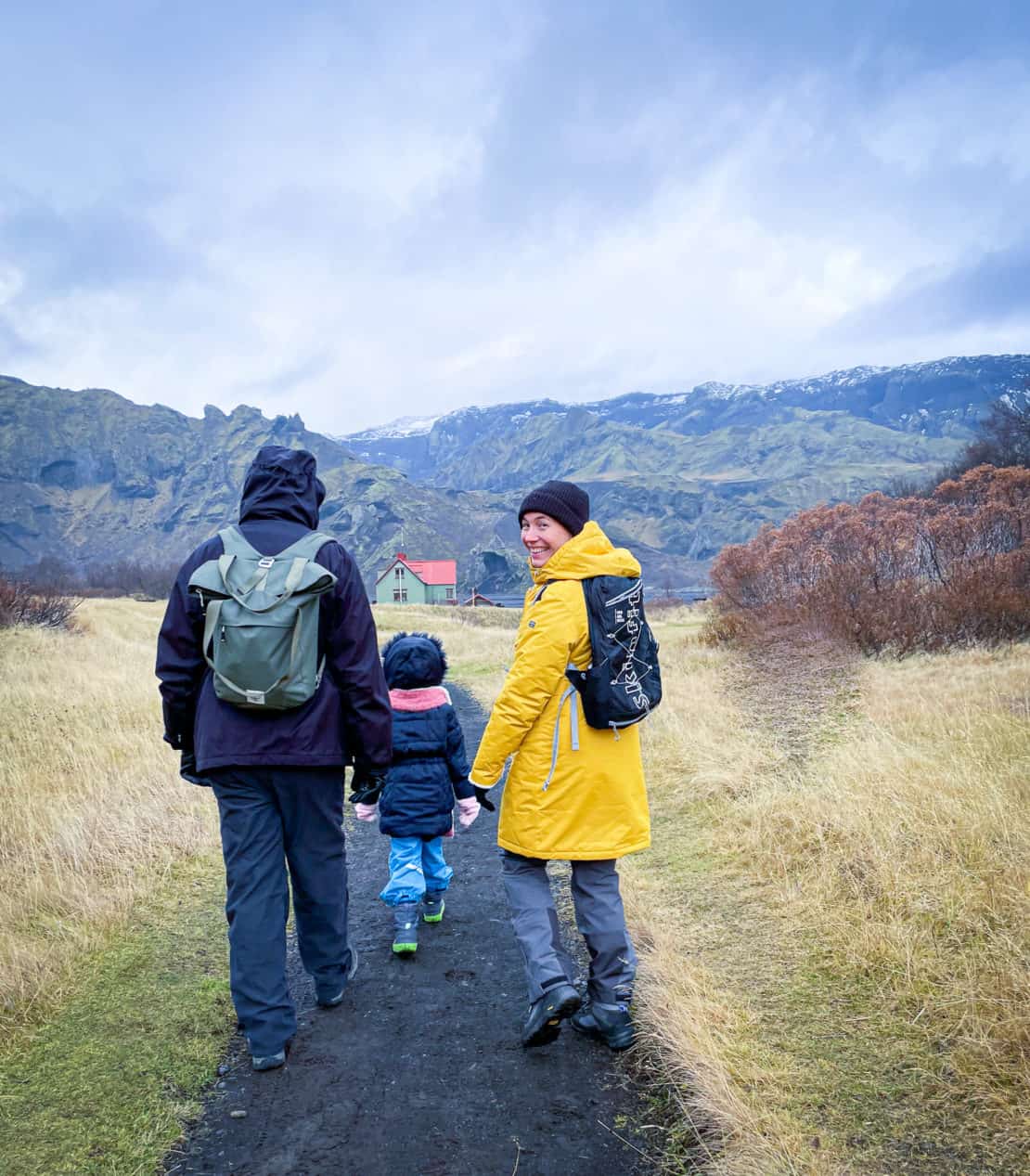 Iceland - Thorsmork park - family walking on a path towards a church