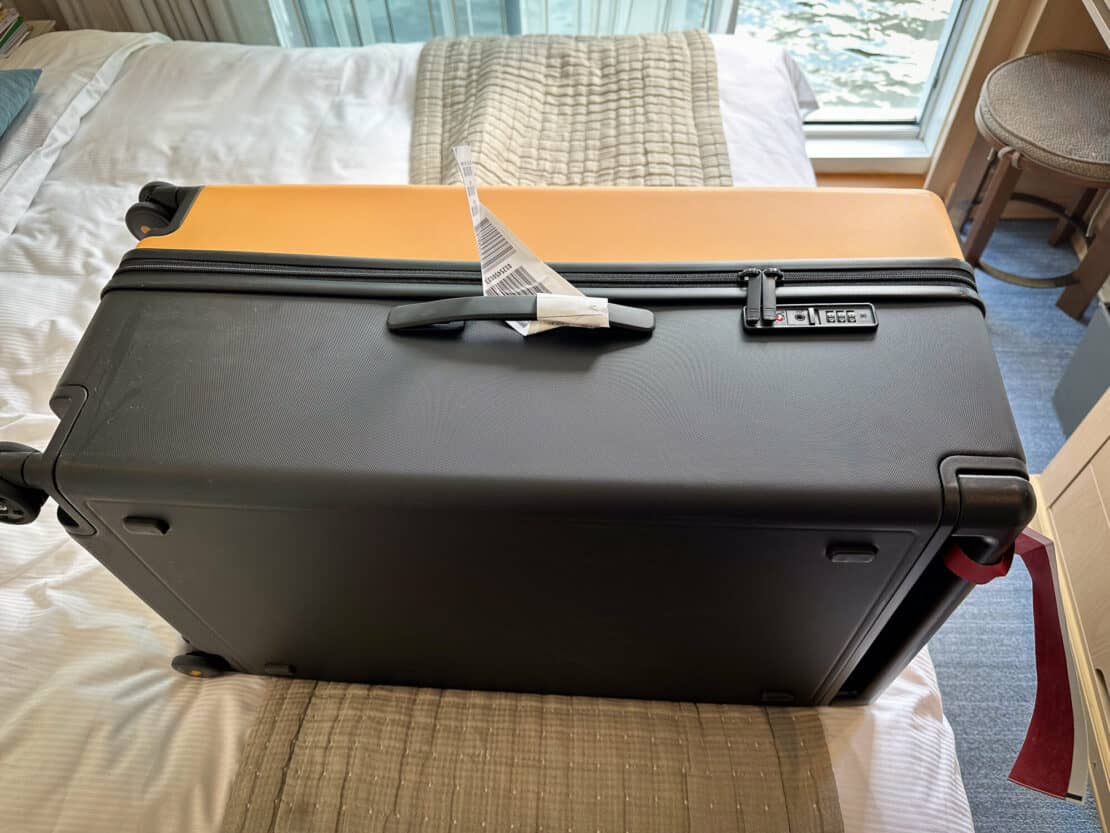 Closed Level8 suitcase on a bed, level8 luggage review 