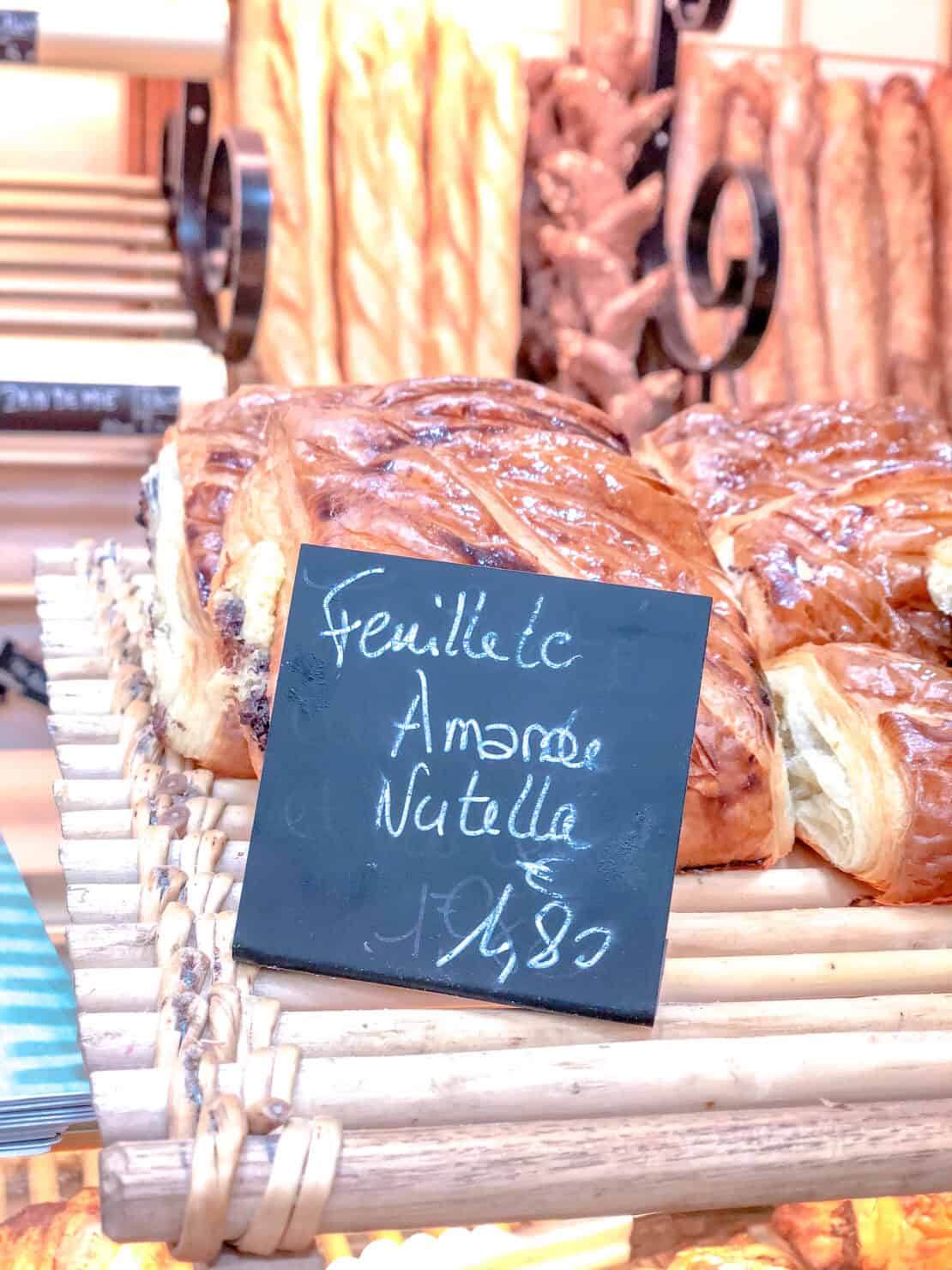 Hand written sign in French selling pastries and baguettes in Paris