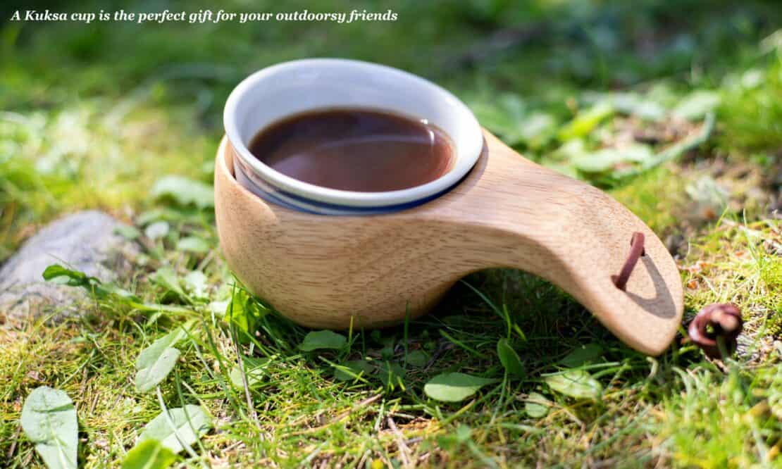 Kuksa cup full of coffee on the grass - best Helsinki souvenirs 