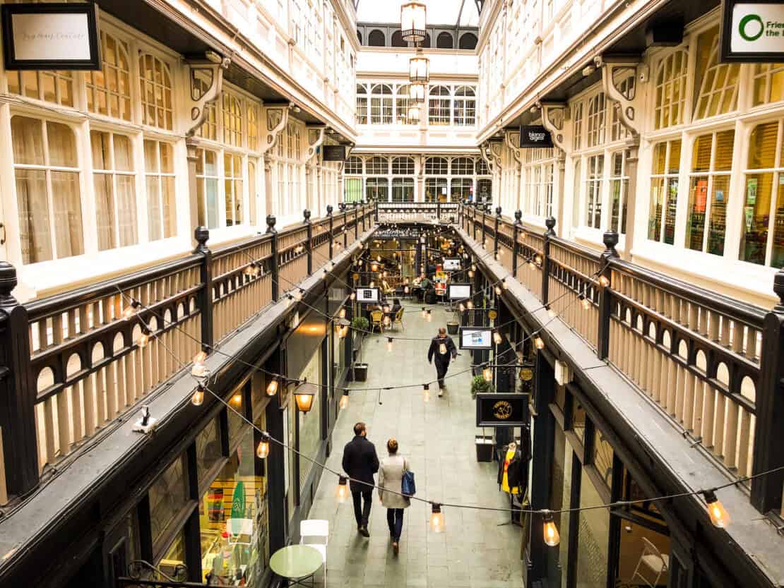 People walking through the Victorian Arcades in Cardiff