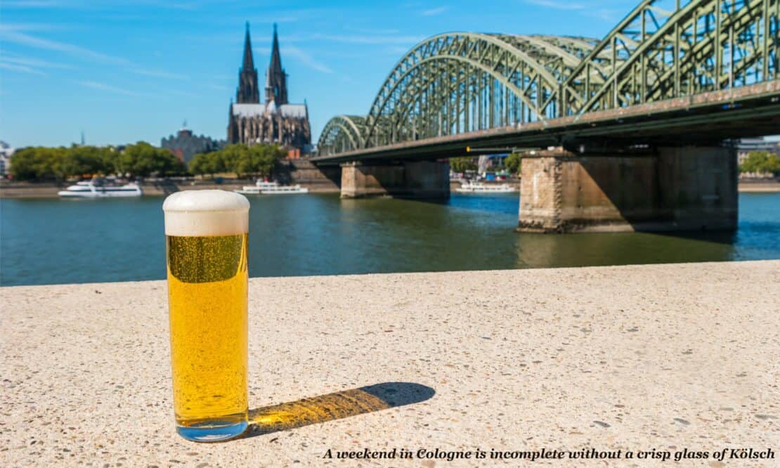 Glass of kölsch on the banks of the river in Cologne, Germany 