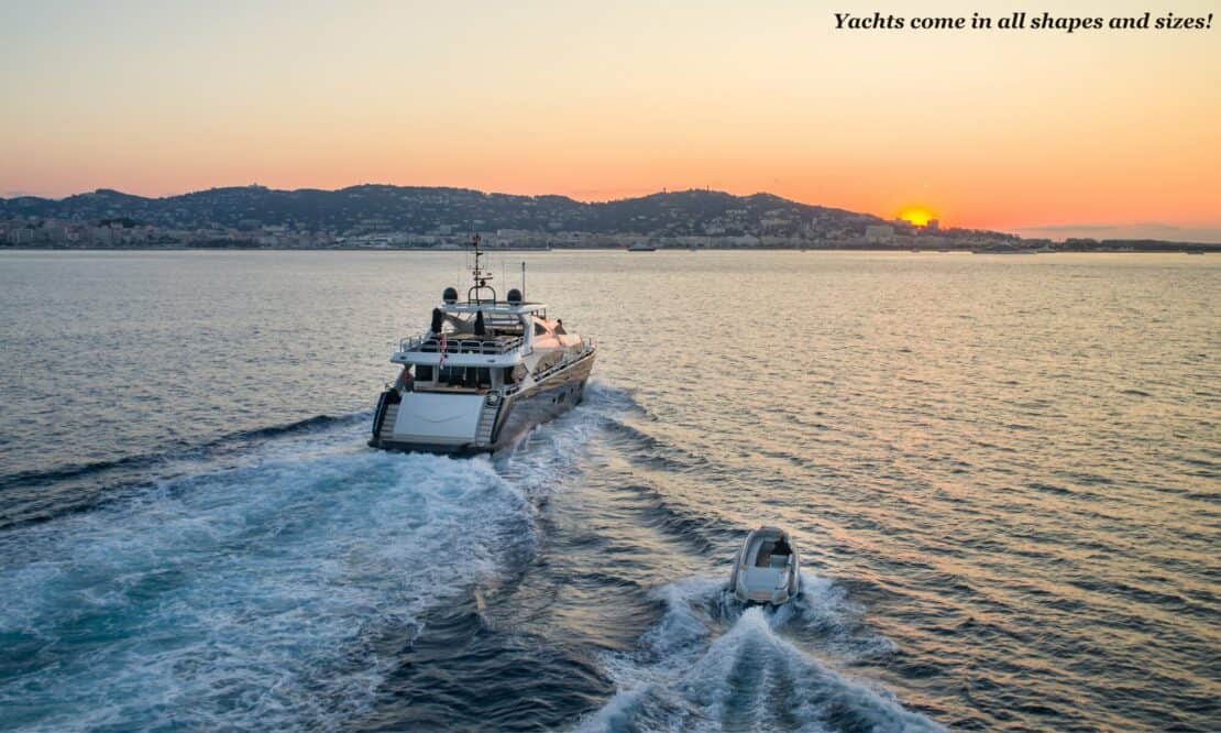 Yacht and tender sailing on open seas at sunset - best yacht rental deals 