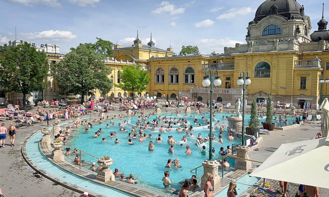 Szechenyi Baths full of people on a sunny day in Budapest, Hungary 