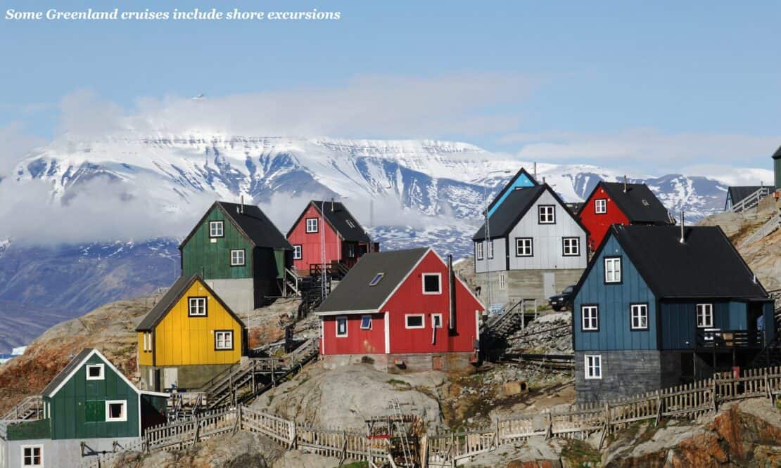 Colourful houses on a cliff side in Greenland - organise a cruise to Greenland 