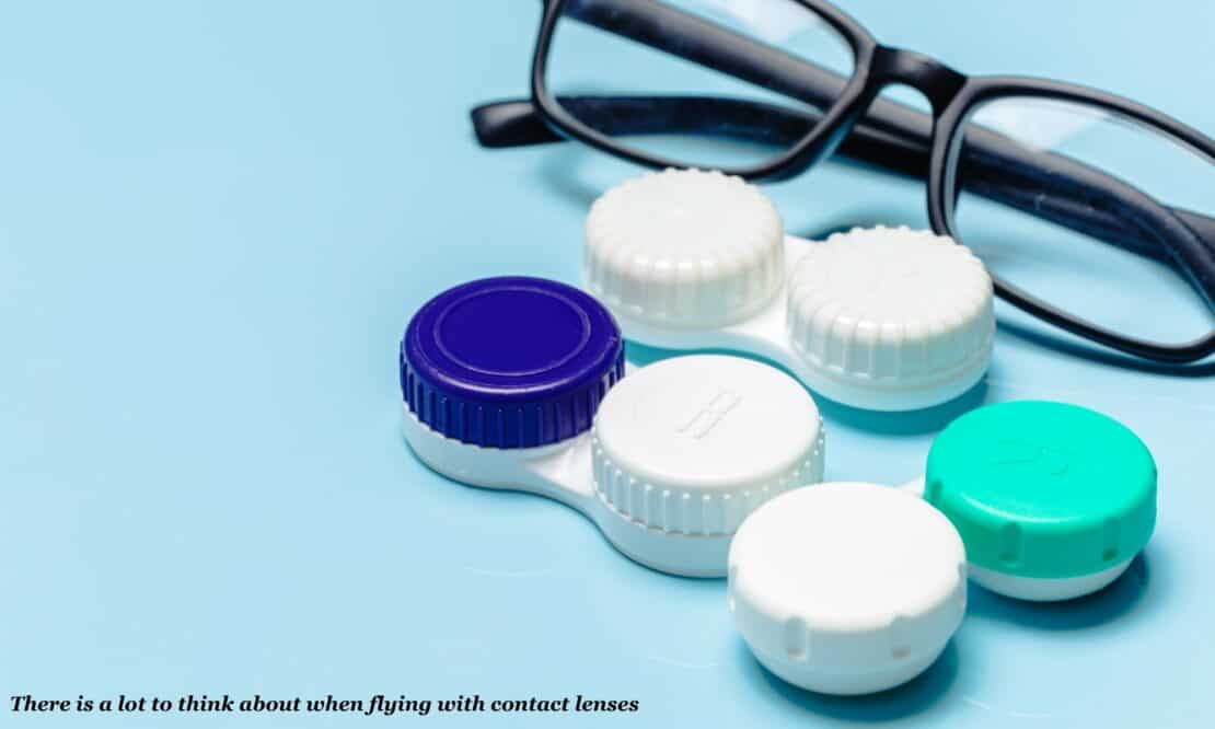 Glasses and contact lense cases on a table -  flying with contact lenses