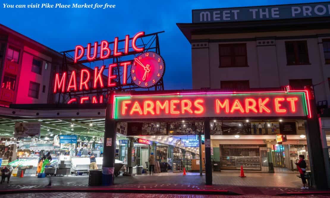 Neon signs outside Pike Place Market in Seattle at night - is Seattle worth visiting 