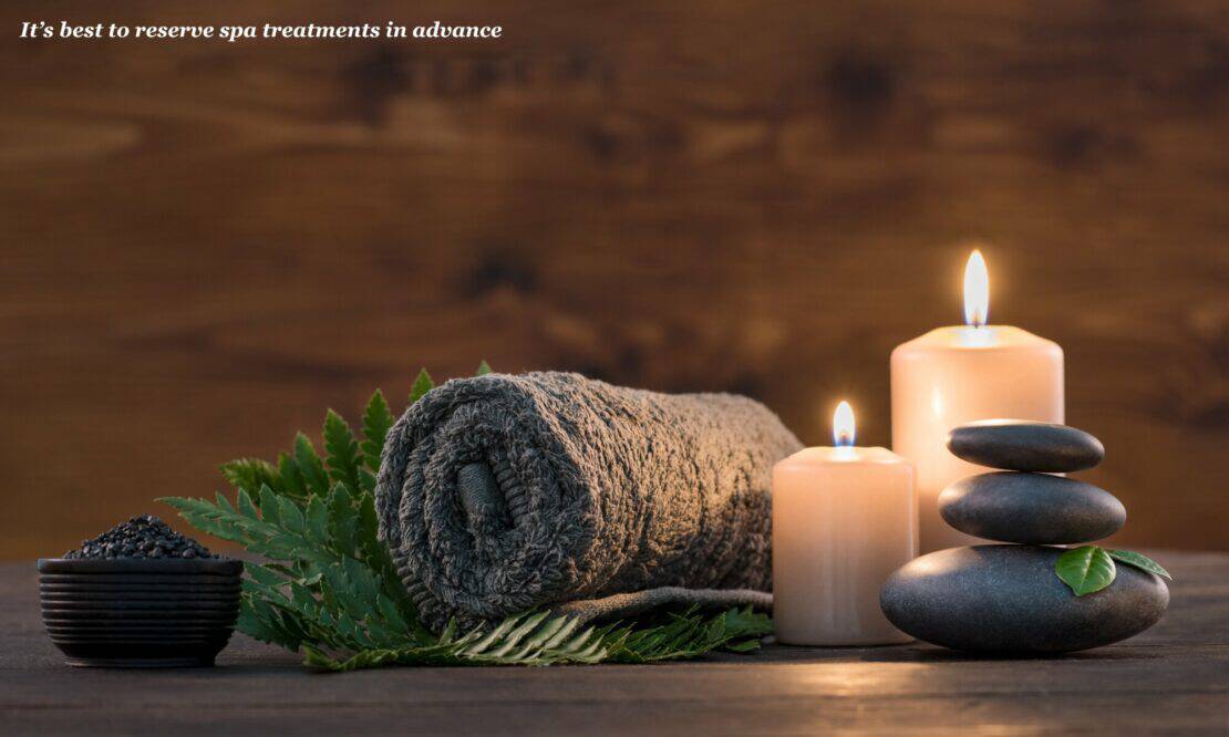 Towel and candles displayed on table at a spa - luxury travel tips 