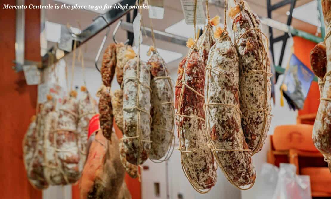 Cured sausages hanging in Mercato Centrale in Florence, Italy - Florence or Milan?