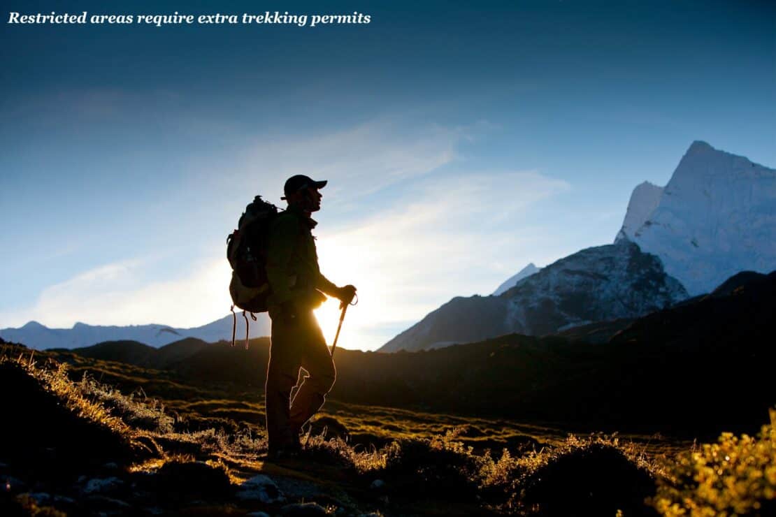 Hiker in the mountains at sunrise in Nepal - Restricted Area Permits in Nepal