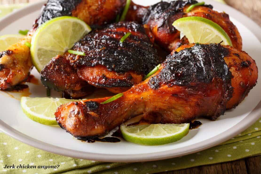 Jerk chicken drumsticks with lime wedges - Jamaica vs Barbados 