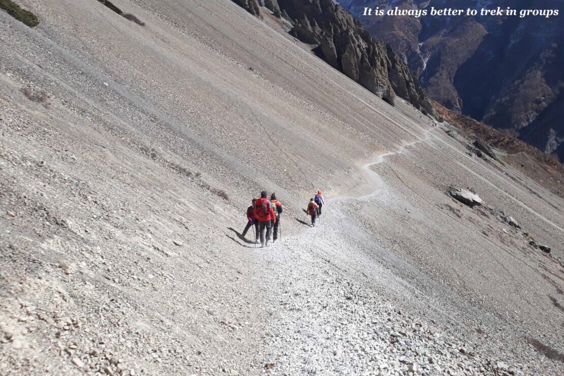 Group of trekker on a rocky cliff face in Nepal - Restricted Area Permits in Nepal